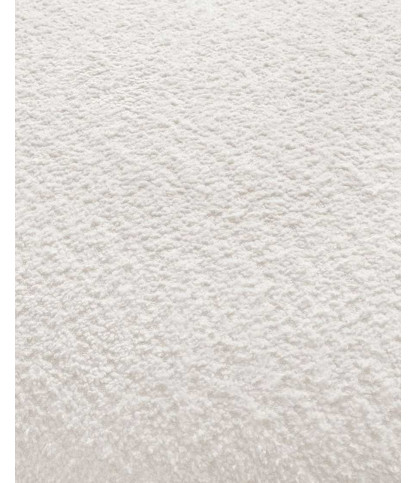 Hestia - Sofá esquinero redondeado en tejido bouclé blanco.
